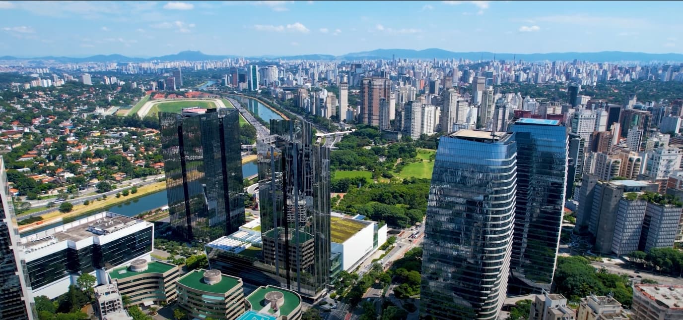 Endless Sao Paulo high-rise skyline dotted with rooftop helipads at dusk