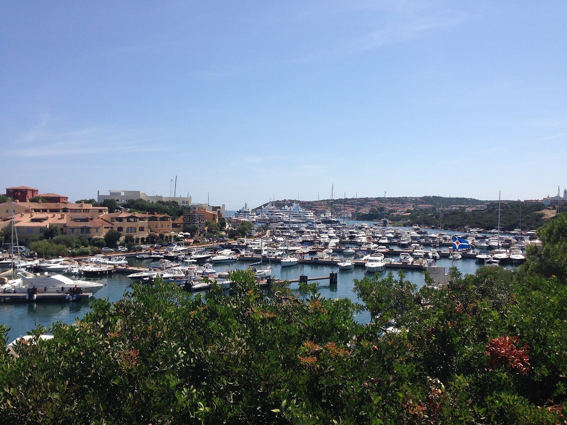 Sardinia's Costa Smeralda coastline with turquoise coves and moored superyachts