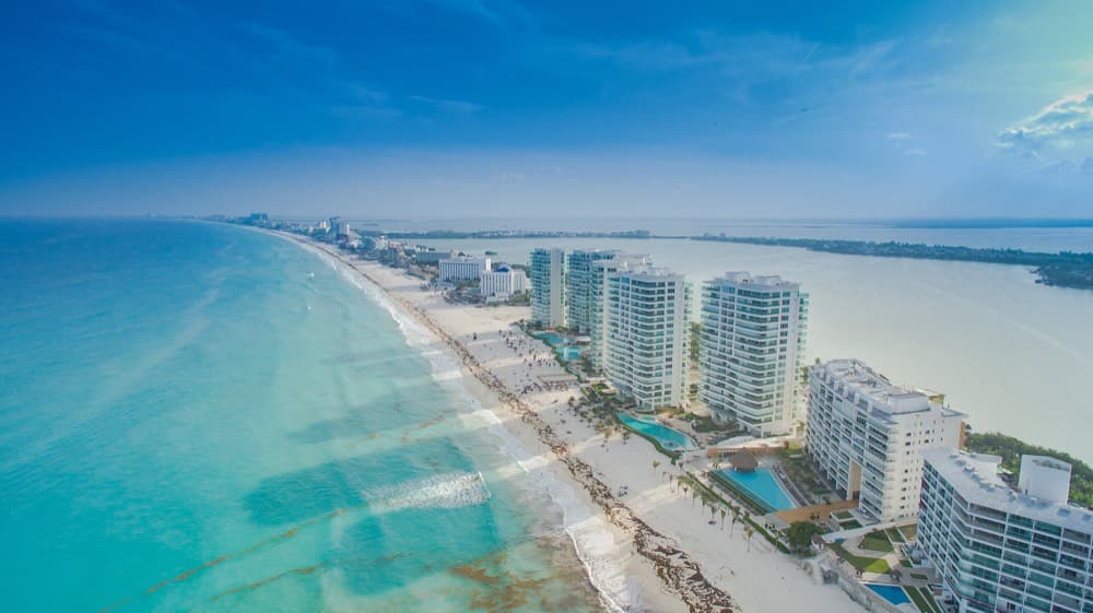 Turquoise Caribbean water meeting the white sand of Cancun's hotel zone