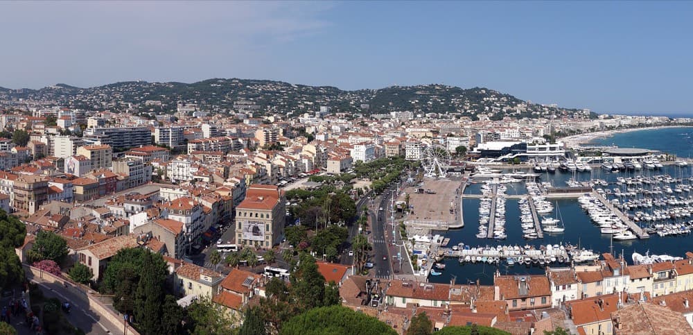 Yachts moored along the Croisette below the Cannes hills at sunset