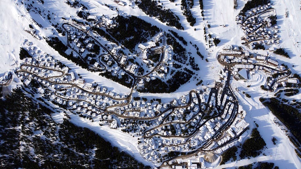Snow-covered chalets and pistes above the alpine village of Courchevel 1850