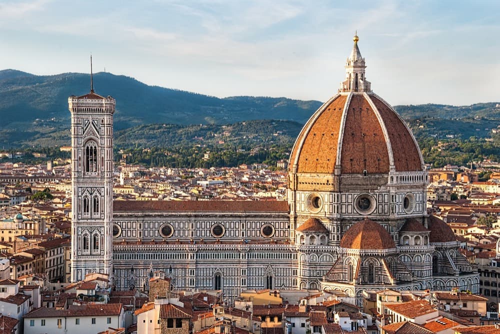 Florence's terracotta rooftops and the Duomo dome above the Arno at sunset