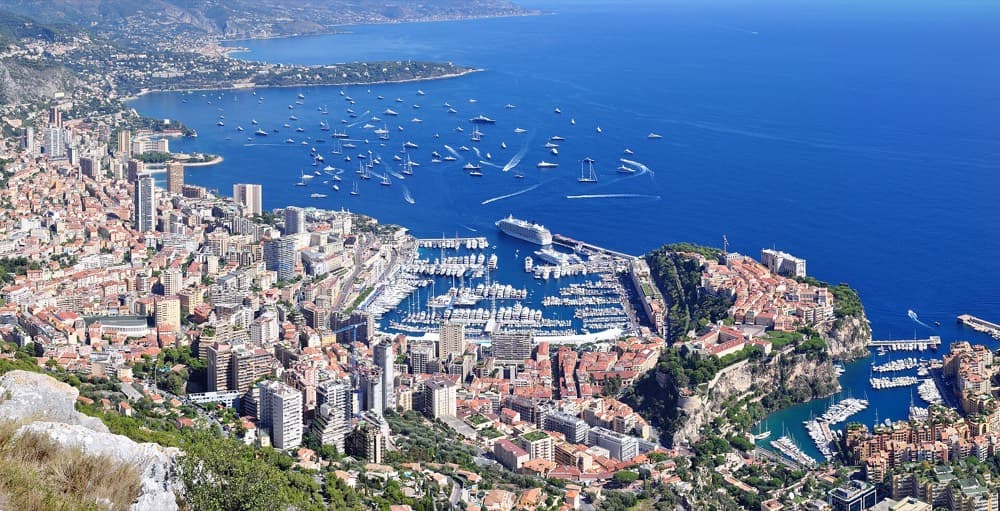 Superyachts packed into Port Hercule below Monaco's cliffside towers on the Riviera