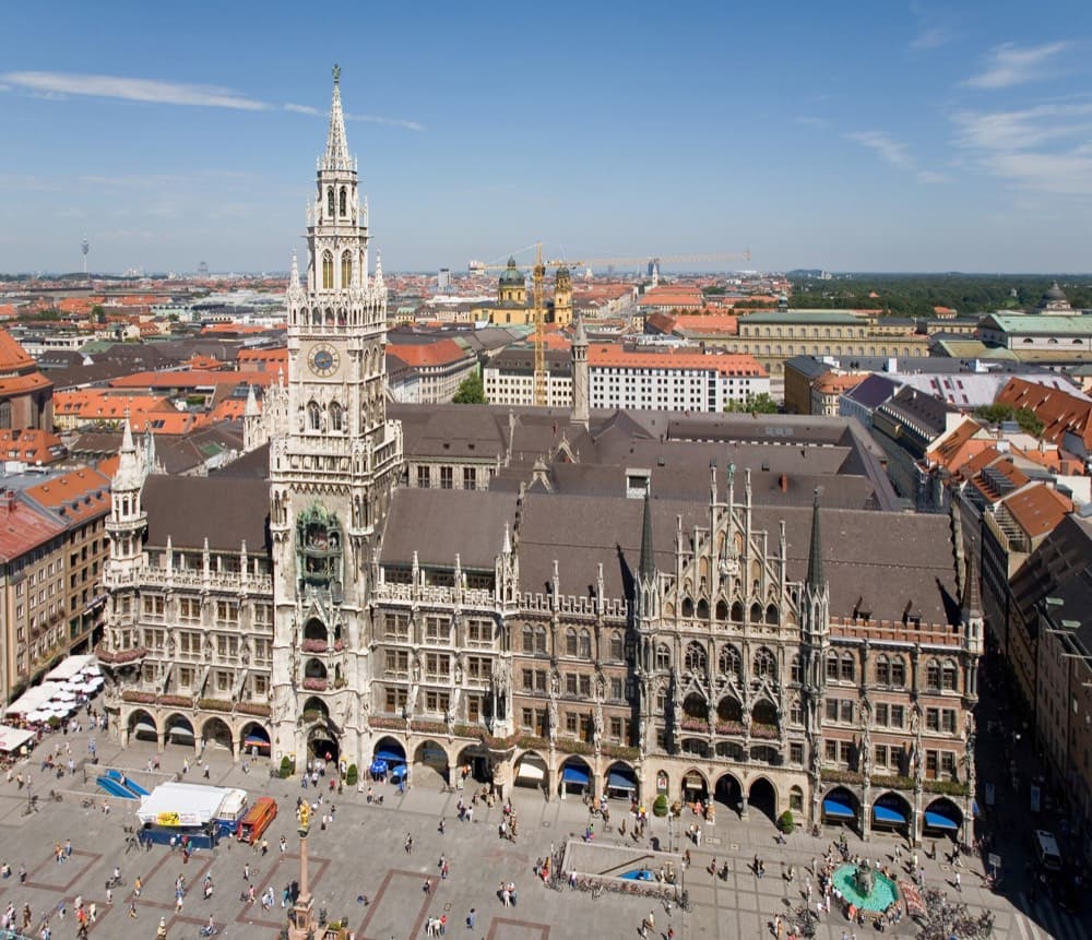 Munich's Frauenkirche twin towers above the old town with Alps on the horizon