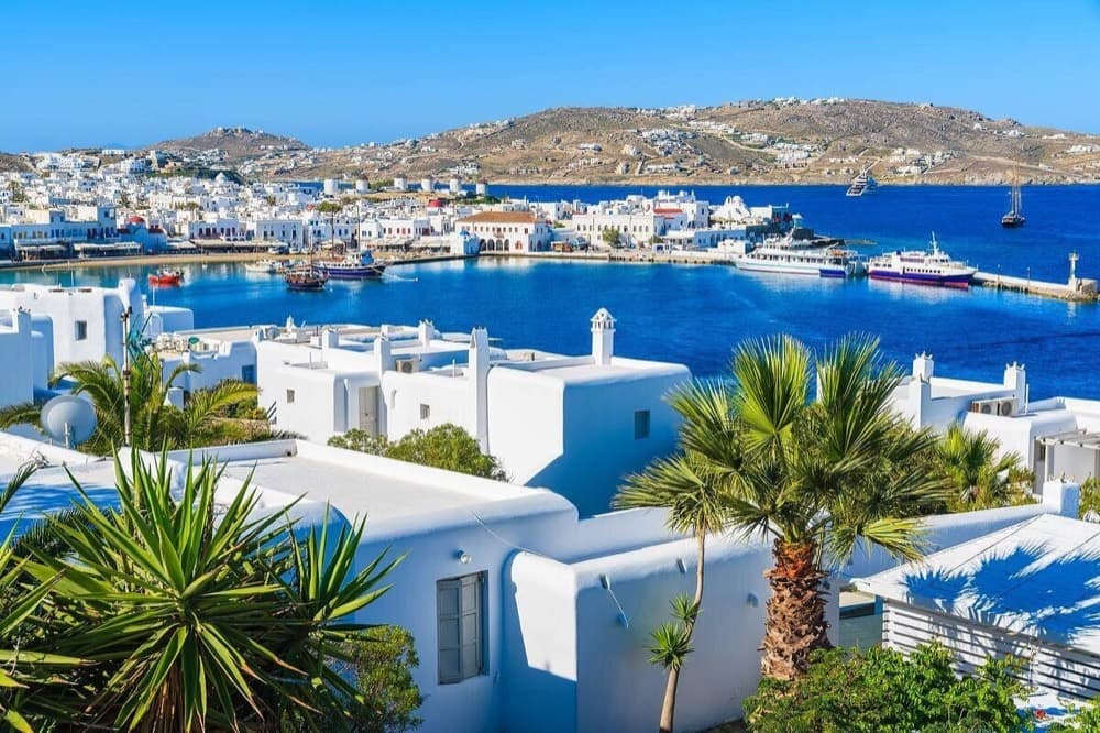 Whitewashed windmills and Little Venice above the Aegean Sea on Mykonos