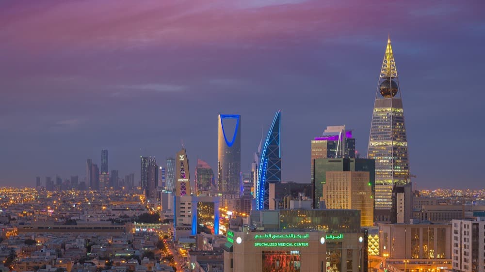 Riyadh skyline with the Kingdom Centre tower rising above the desert at sunset