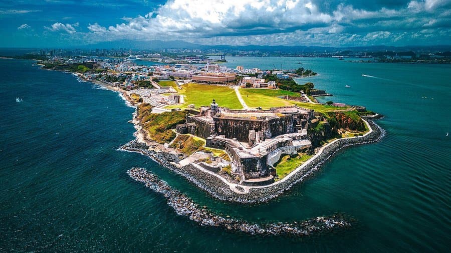 Aerial view of El Morro fortress on the tip of Old San Juan, ringed by turquoise Caribbean water
