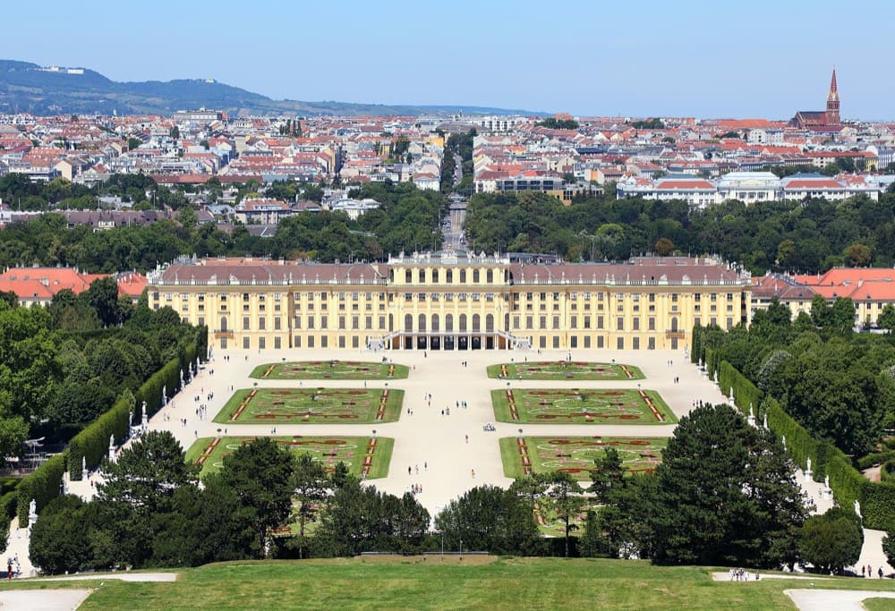 Vienna's Schonbrunn Palace and baroque skyline under soft golden evening light