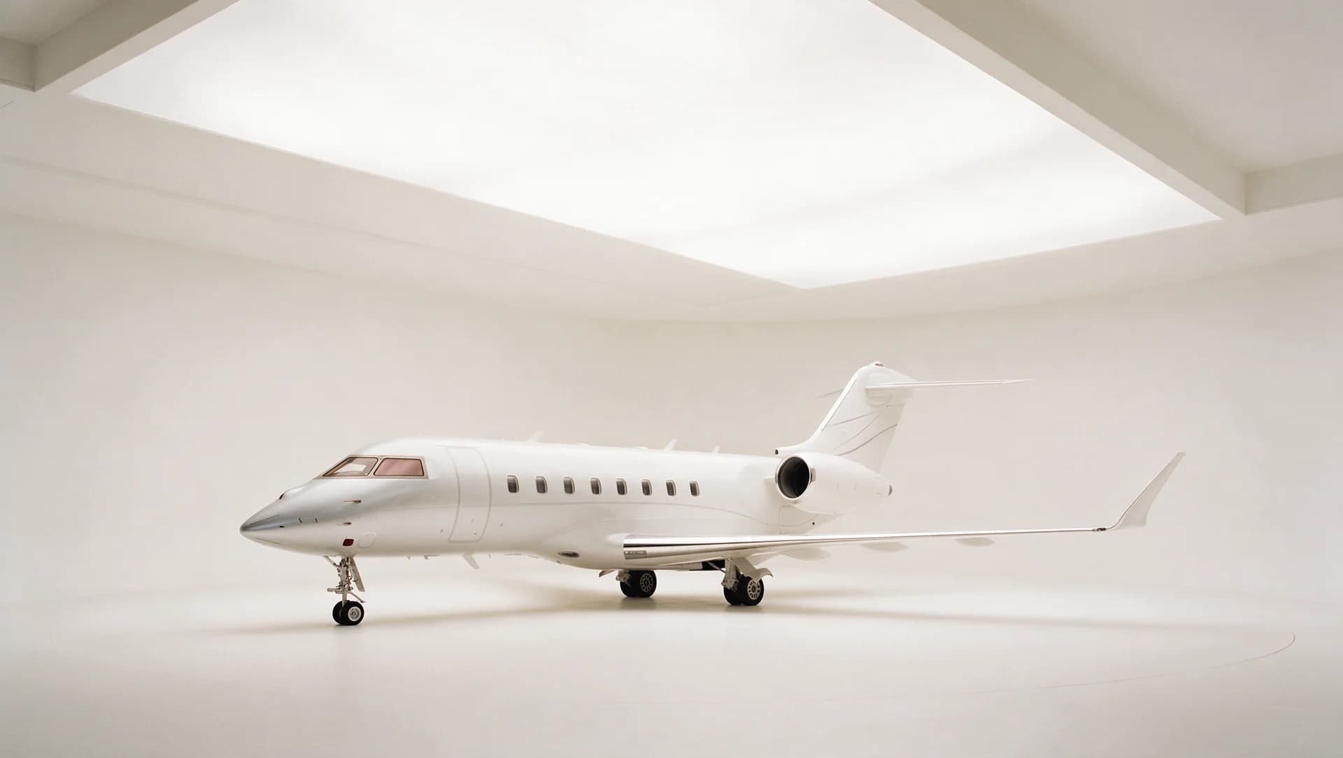 Super-midsize jet in a white hangar
