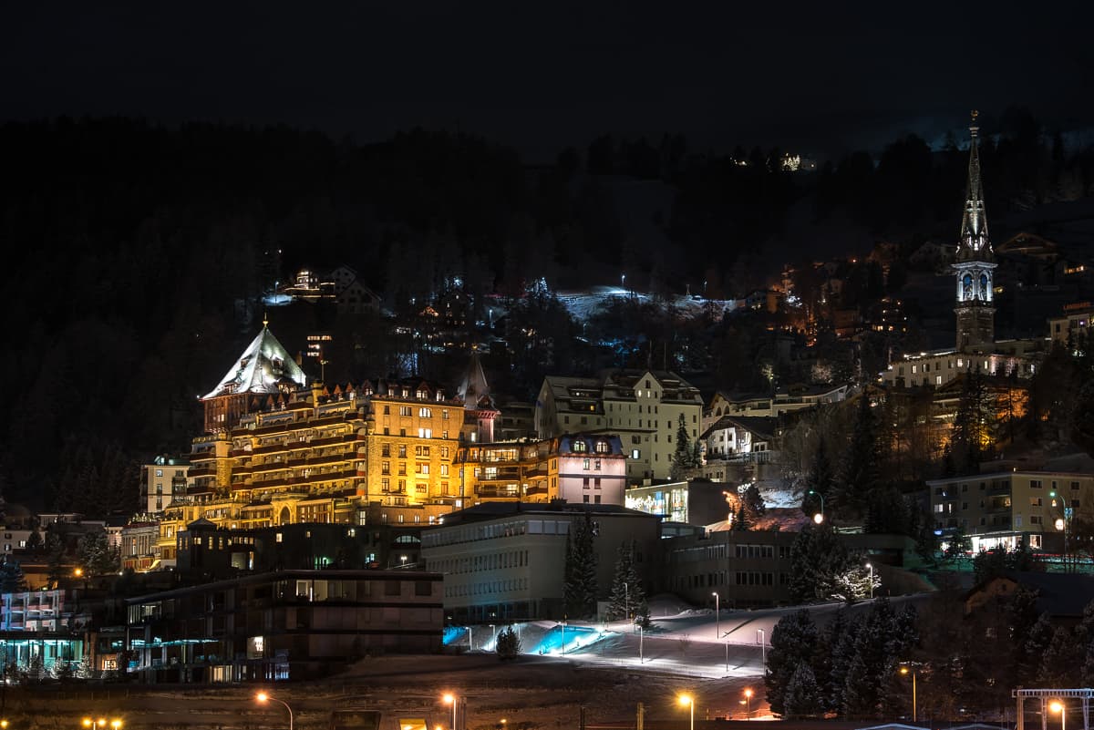 The frozen lake and grand hotels of St. Moritz beneath the snow-capped Engadin peaks